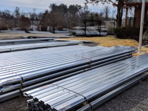 Metal decking is laying on a job site during the daytime. 